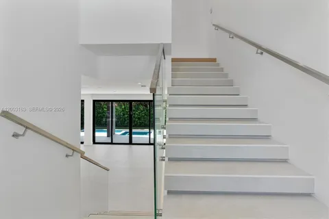 wooden floor in an empty room with large windows