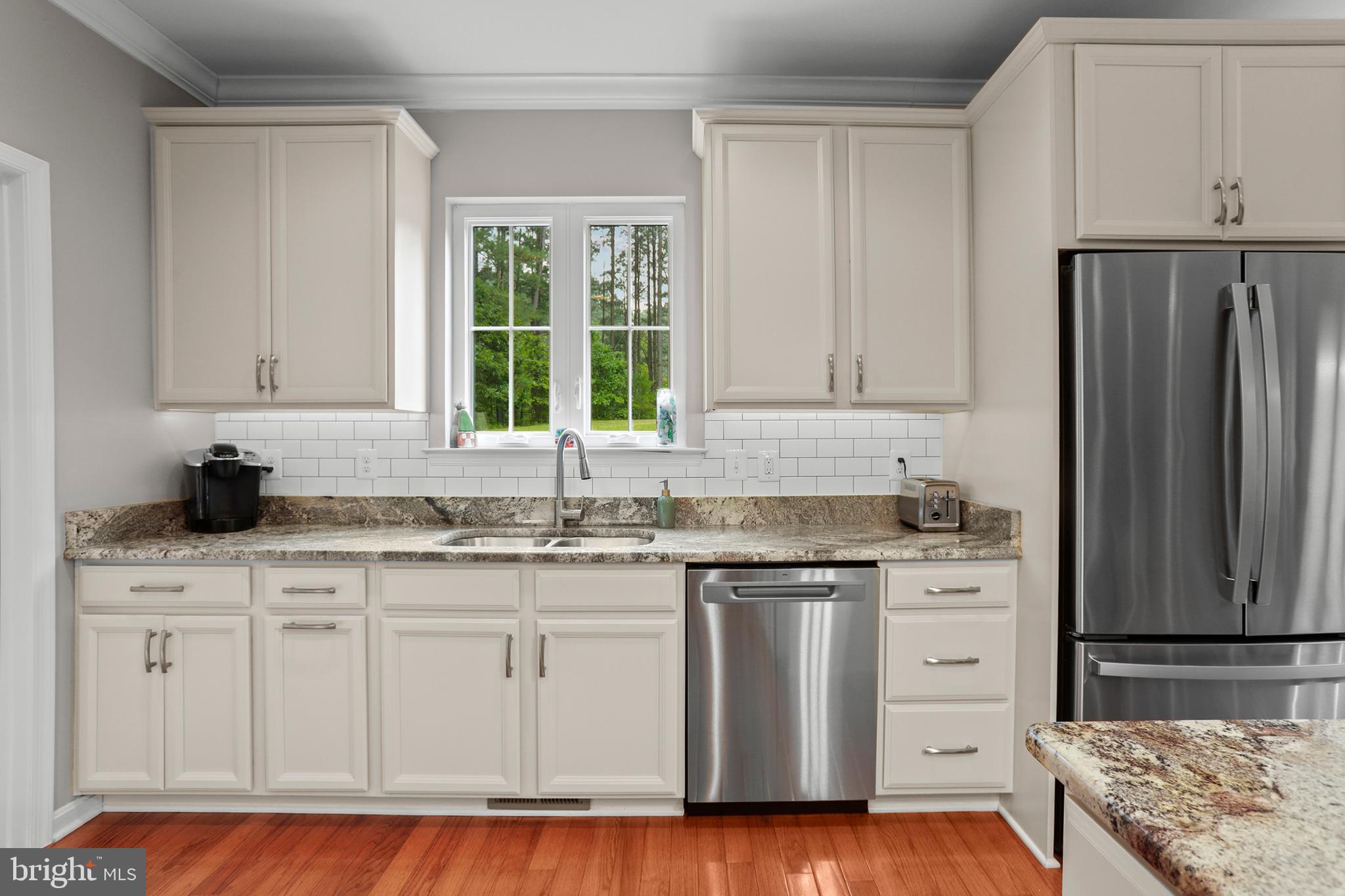 8264 Buckthorne Run King George, VA 22485 - Photo 12 of 50 a kitchen with stainless steel appliances granite countertop a sink stove and refrigerator