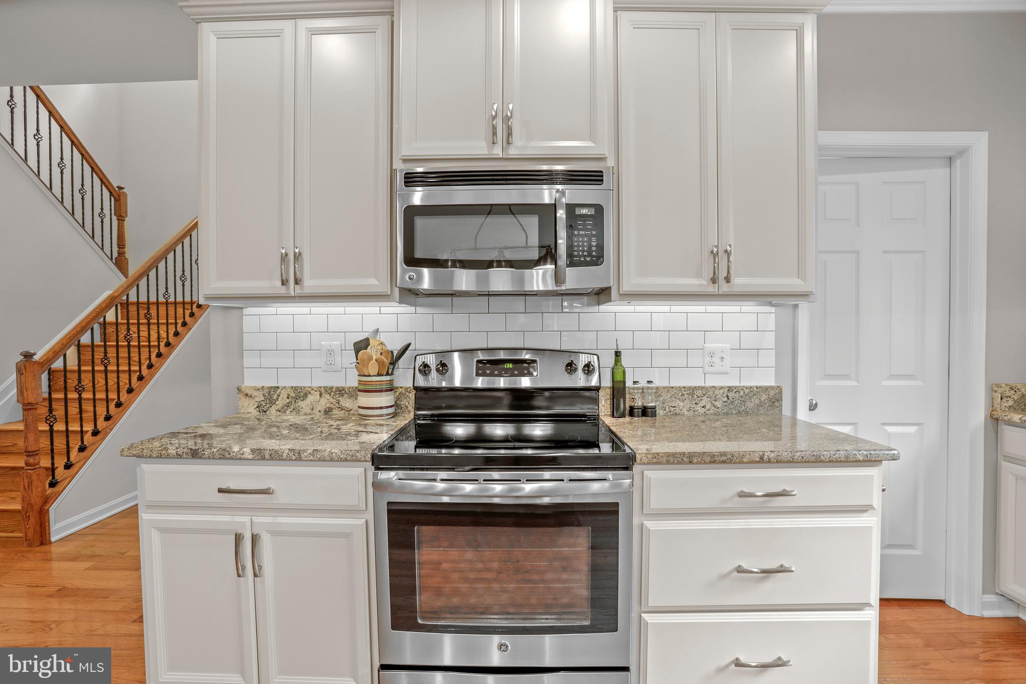 8264 Buckthorne Run King George, VA 22485 - Photo 13 of 50 a kitchen with granite countertop a stove and a sink