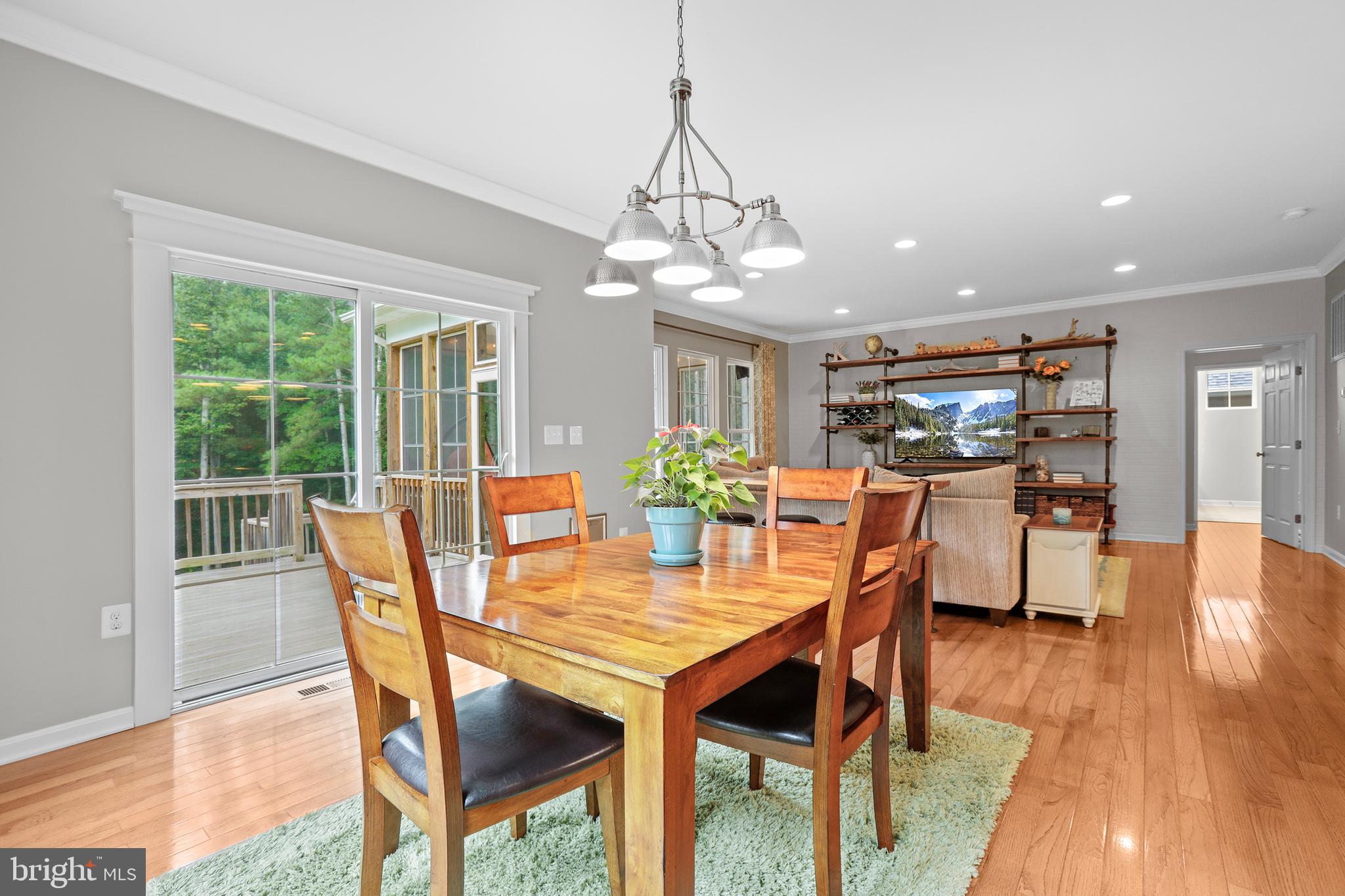 8264 Buckthorne Run King George, VA 22485 - Photo 15 of 50 a dining room with furniture a chandelier and wooden floor