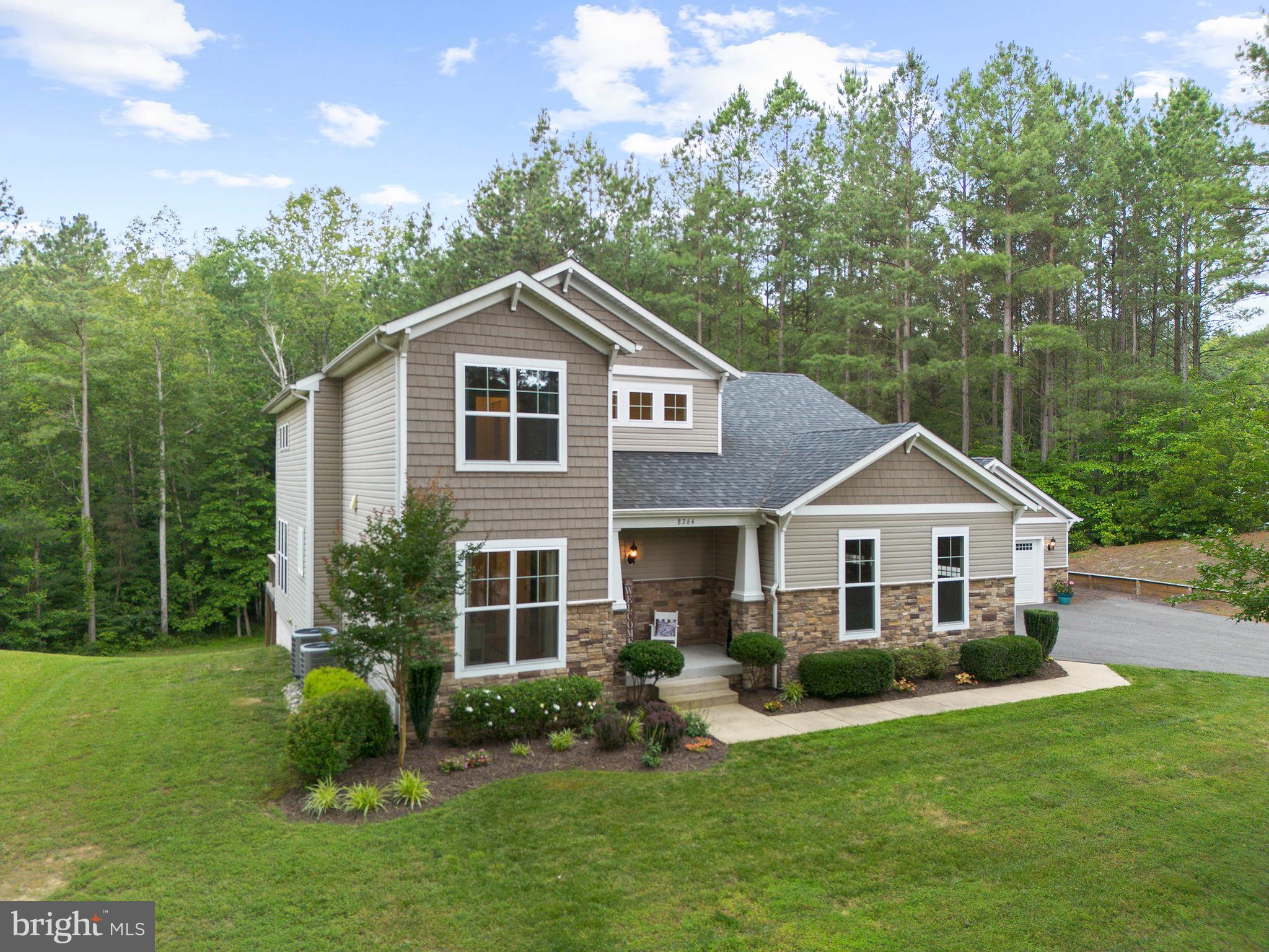 8264 Buckthorne Run King George, VA 22485 - Photo 2 of 50 a front view of a house with a yard and trees