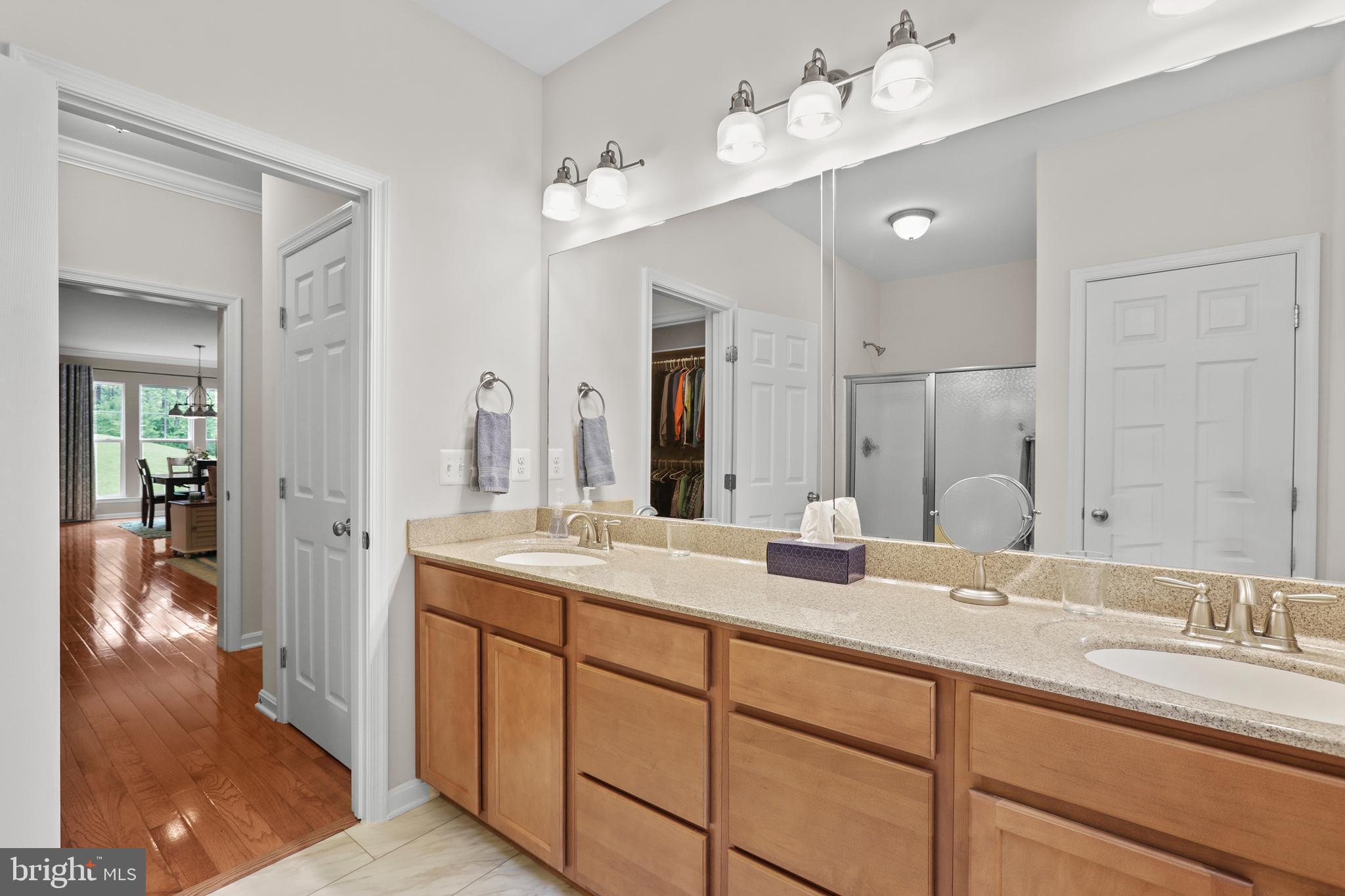 8264 Buckthorne Run King George, VA 22485 - Photo 28 of 50 a bathroom with double vanity sinks and a mirror