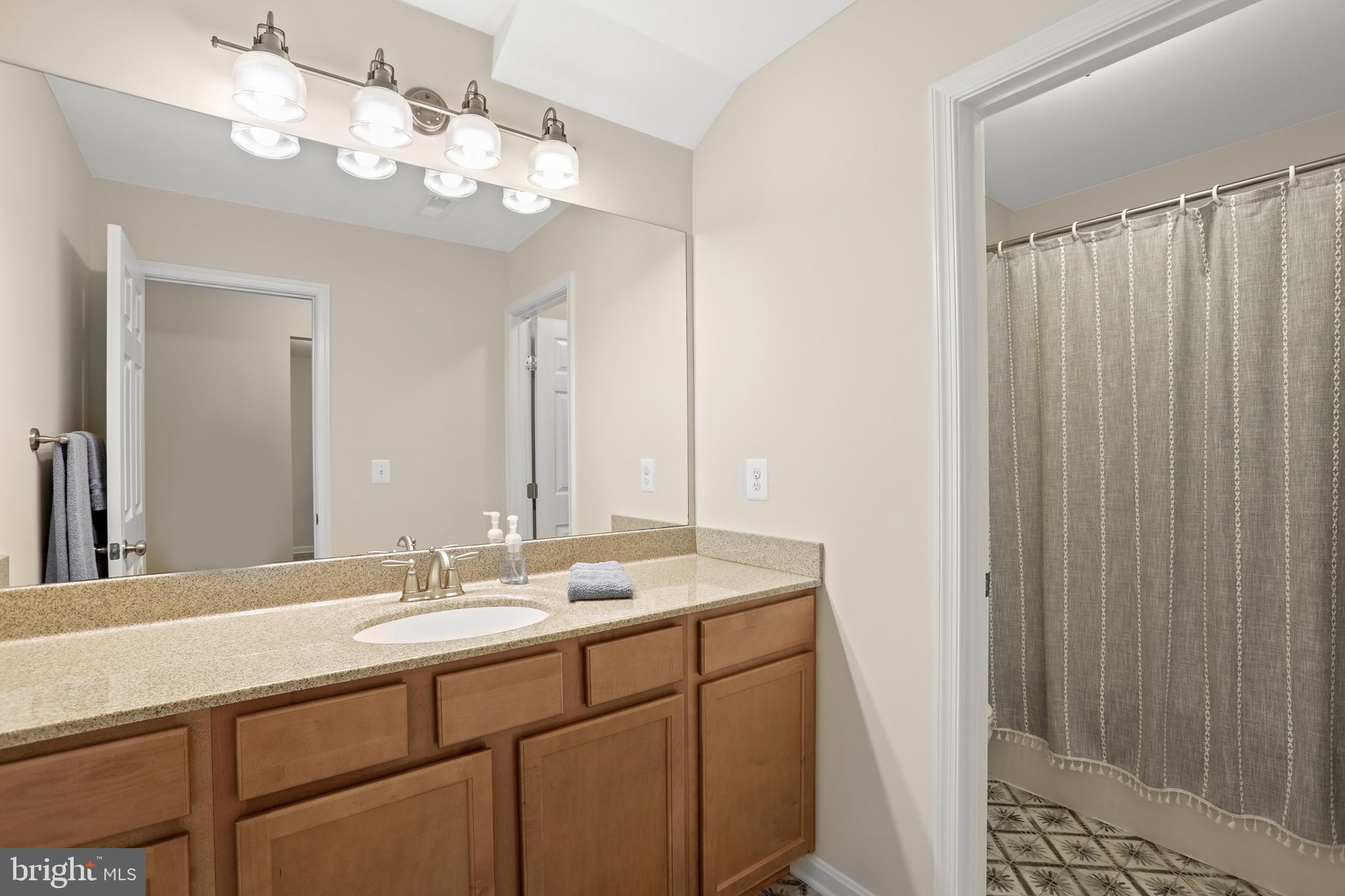 8264 Buckthorne Run King George, VA 22485 - Photo 34 of 50 a bathroom with a double vanity sink and a mirror