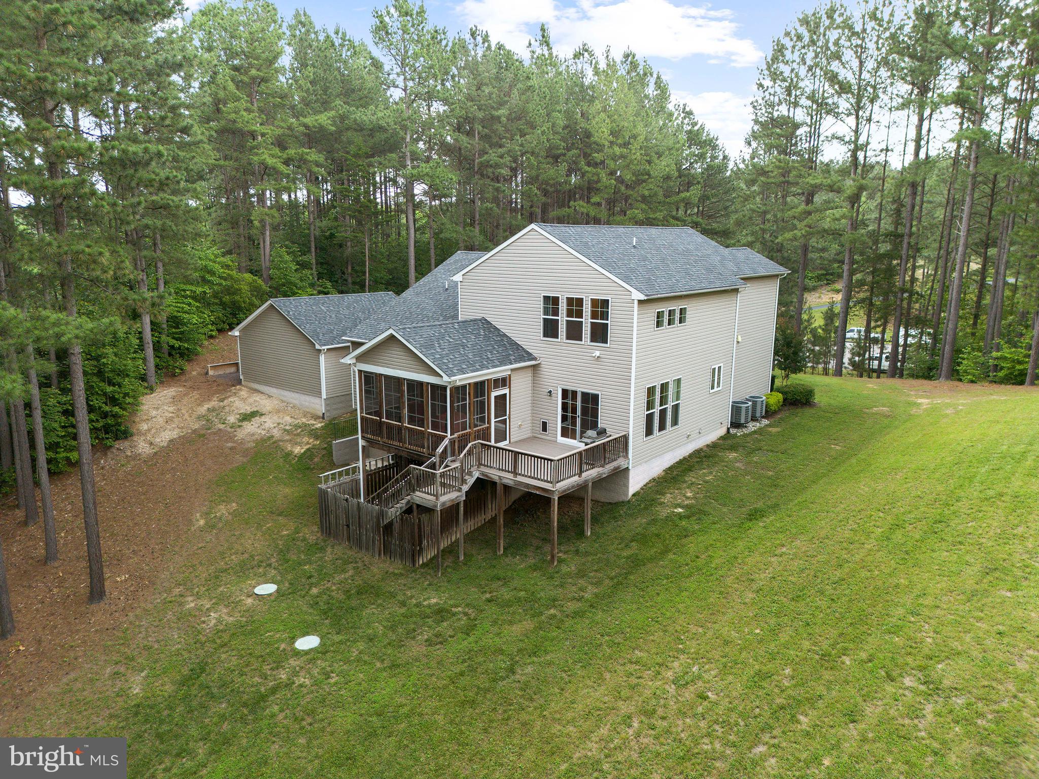 8264 Buckthorne Run King George, VA 22485 - Photo 42 of 50 a aerial view of a house with a yard table and chairs