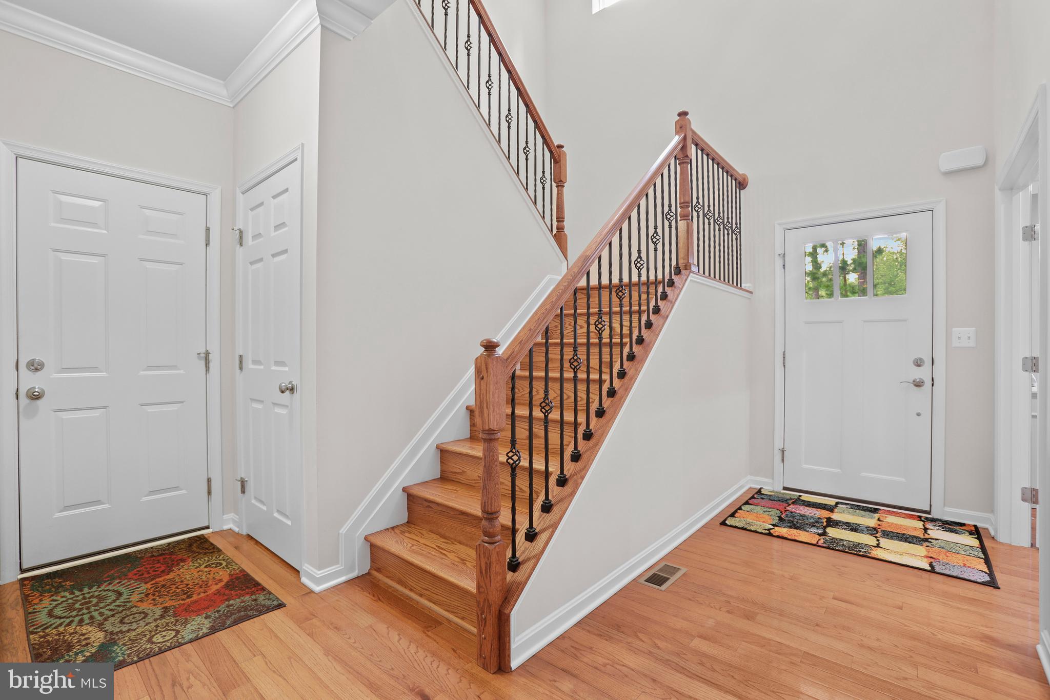 8264 Buckthorne Run King George, VA 22485 - Photo 6 of 50 a view of an entryway with wooden floor and staircase