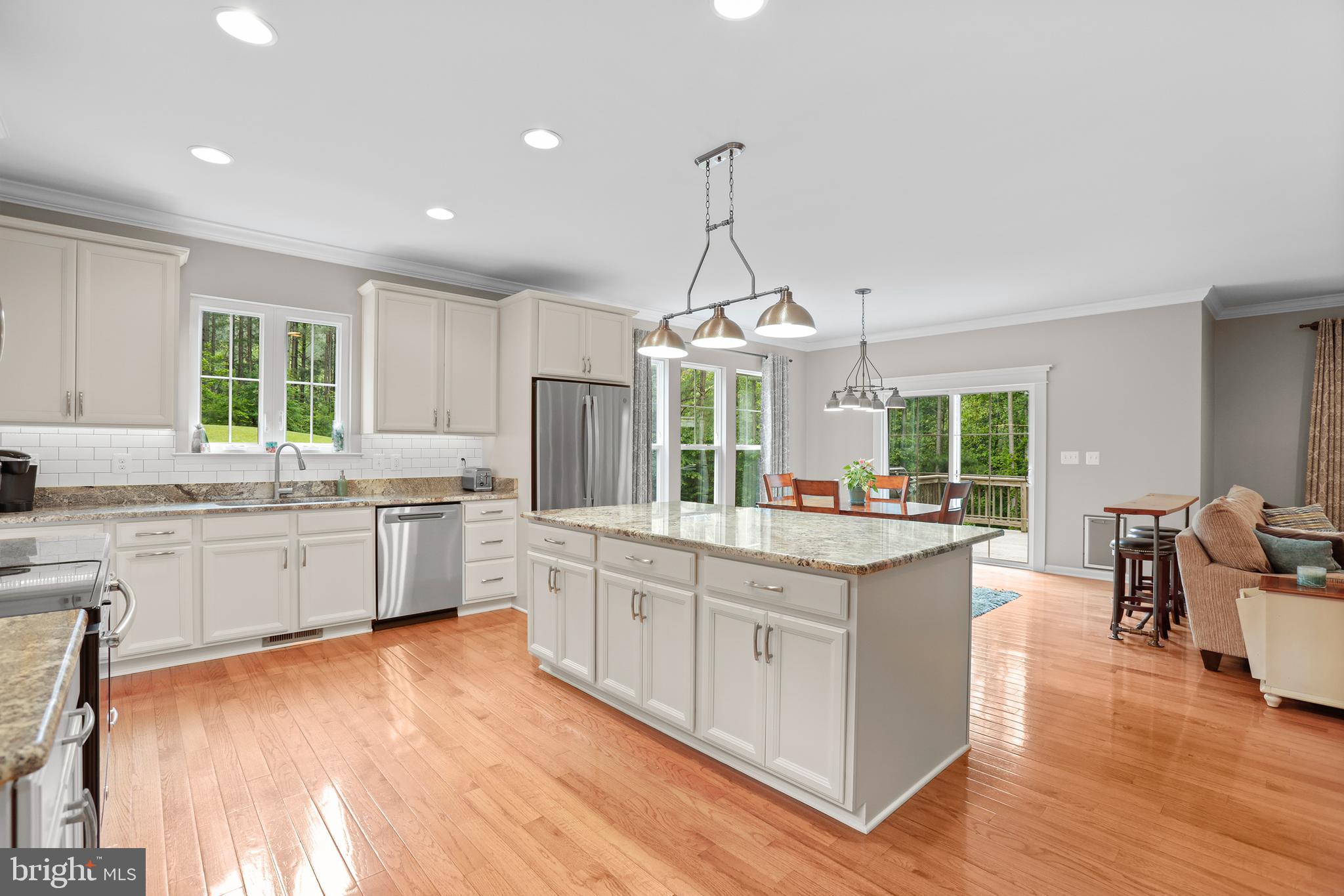 8264 Buckthorne Run King George, VA 22485 - Photo 7 of 50 a kitchen with stainless steel appliances a stove top oven and a wooden floors