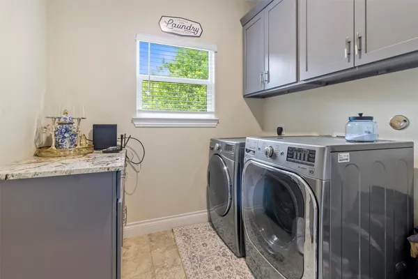 a utility room with sink dryer and washer