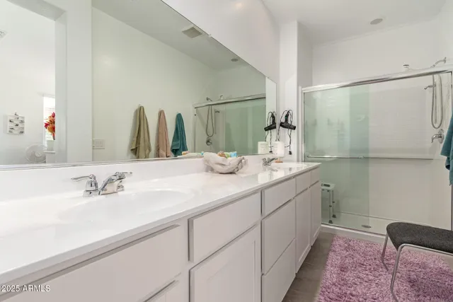 a bathroom with a double vanity sink and a mirror