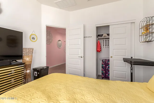 a bedroom with a bed and a flat screen tv