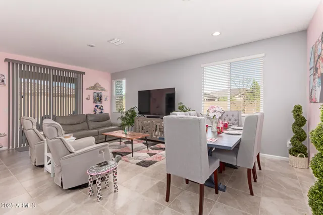 a living room with furniture a flat screen tv and a large window