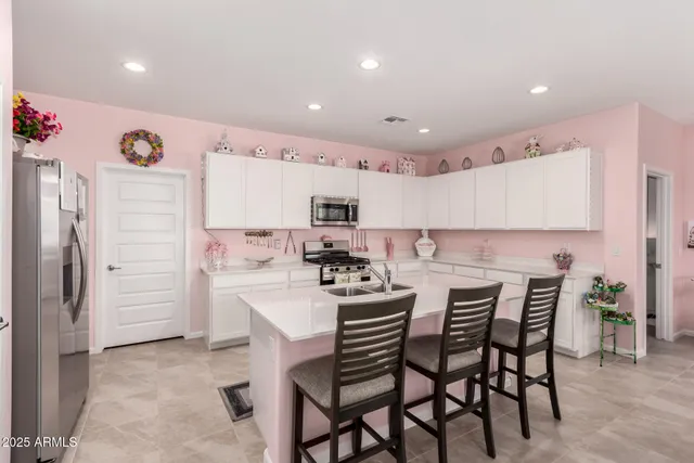 a kitchen with a table and chairs in it