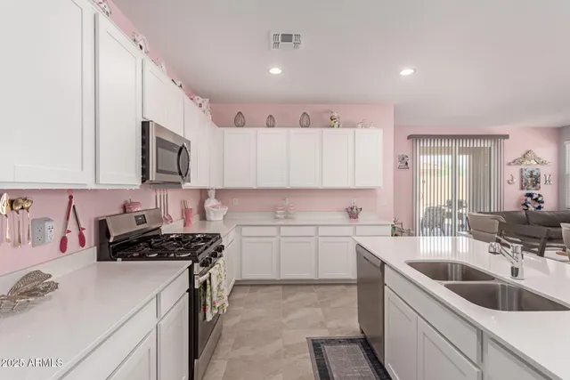 a kitchen with a sink stove top oven and cabinets