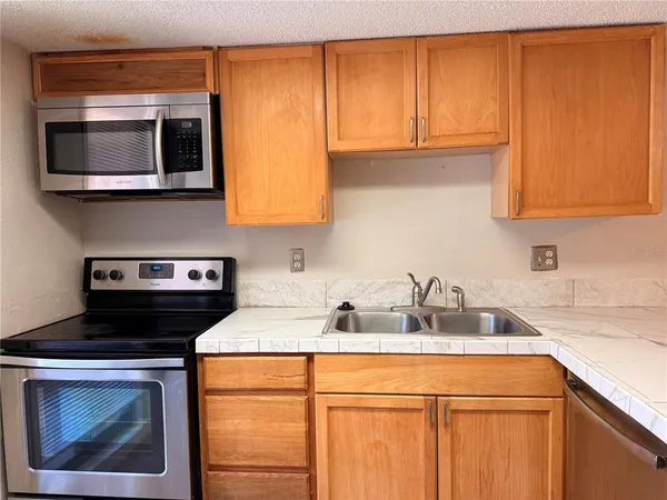 a kitchen with a sink and a microwave