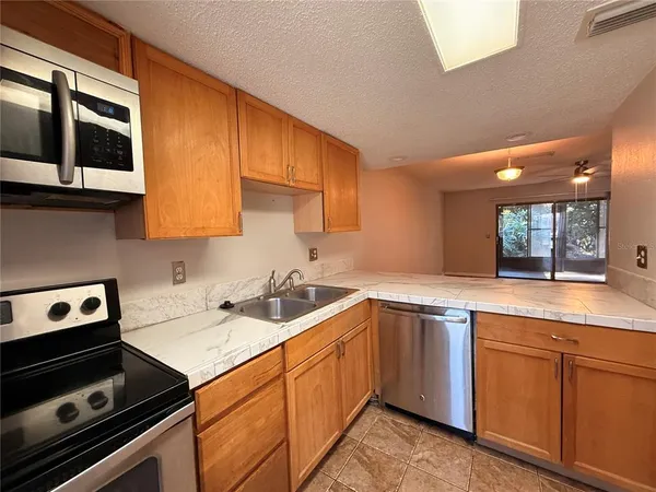 a kitchen with a sink stove and cabinets