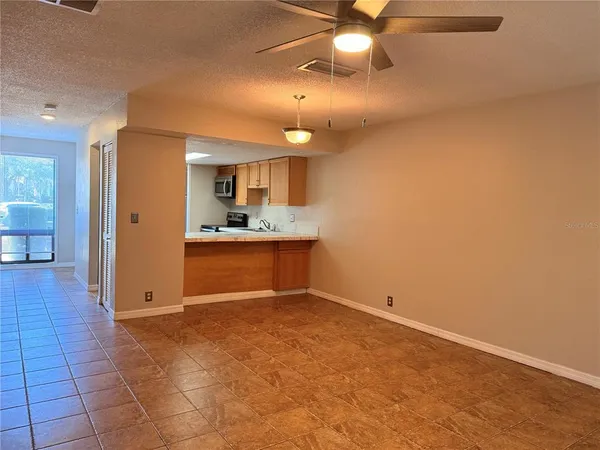 a view of a kitchen with a sink and a cabinet mirror