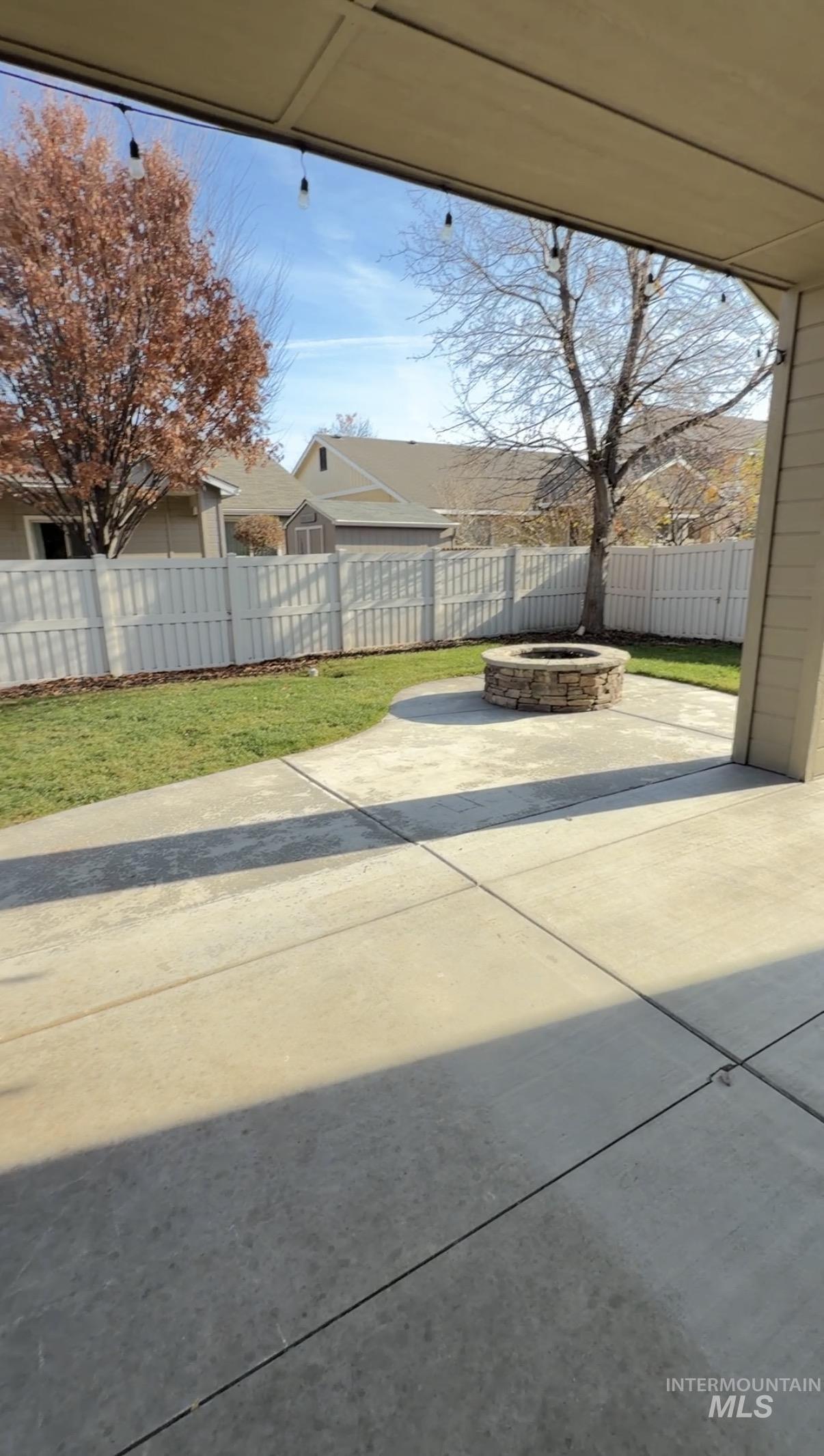 4678 North Elmstone Avenue Meridian, ID 83646 - Photo 13 of 15 Fenced backyard featuring an outdoor fire pit and a patio