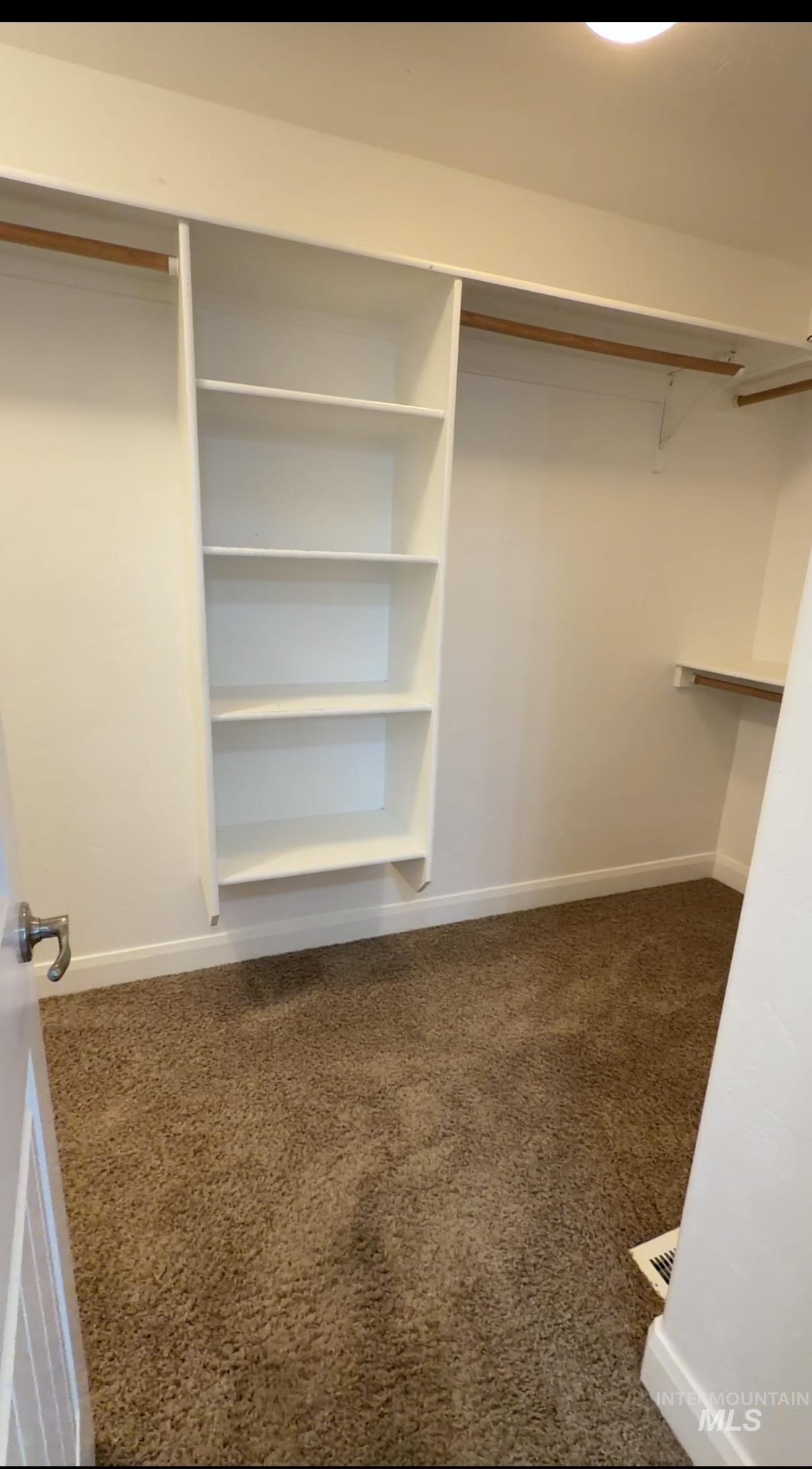 4678 North Elmstone Avenue Meridian, ID 83646 - Photo 8 of 15 Walk in closet featuring dark colored carpet