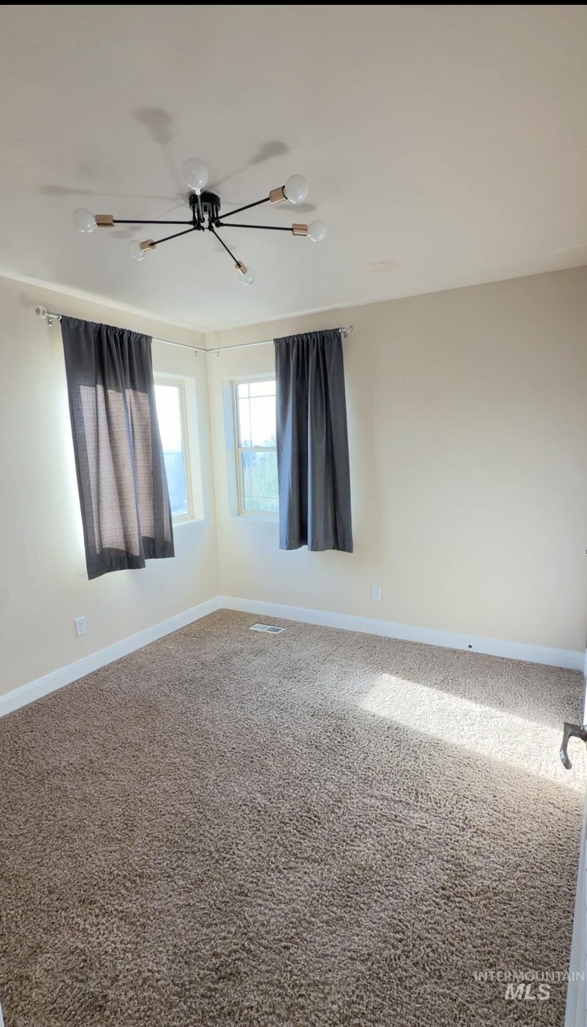 4678 North Elmstone Avenue Meridian, ID 83646 - Photo 9 of 15 Empty room featuring baseboards and carpet flooring
