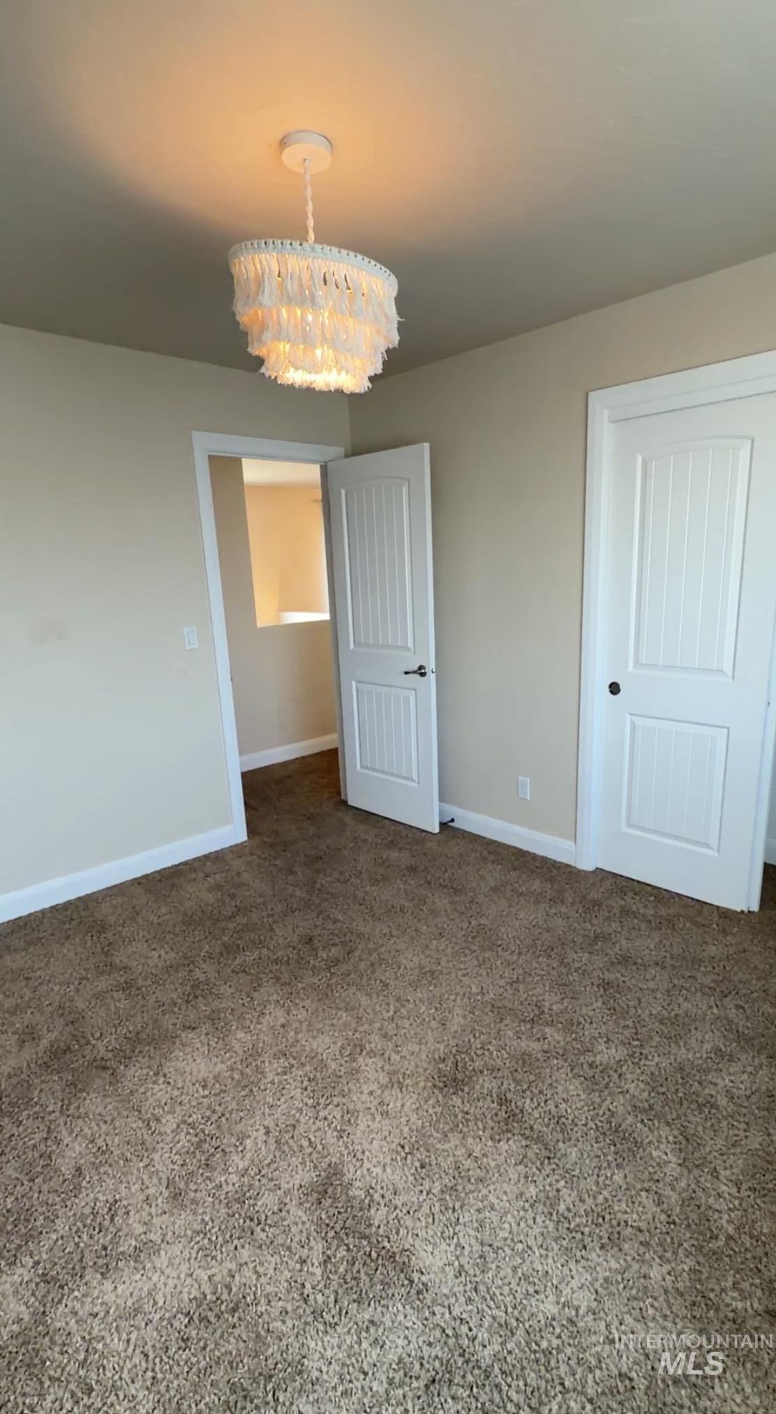4678 North Elmstone Avenue Meridian, ID 83646 - Photo 10 of 15 Unfurnished dining area featuring a chandelier and baseboards