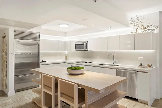a kitchen with a sink a stove and cabinets
