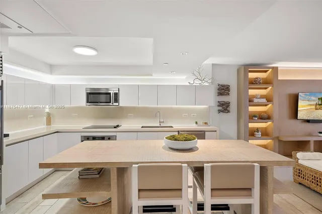 a kitchen with a table chairs and stove