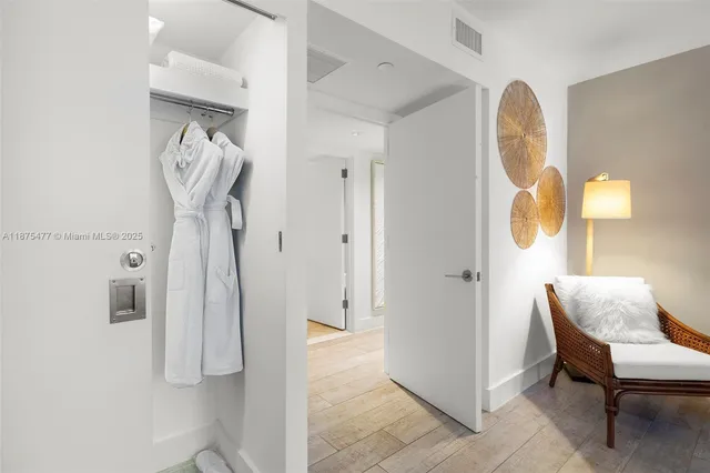 a view of entryway and hall with wooden floor
