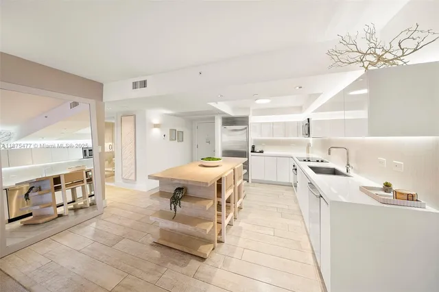 a living room with stainless steel appliances kitchen island granite countertop furniture and a view of kitchen