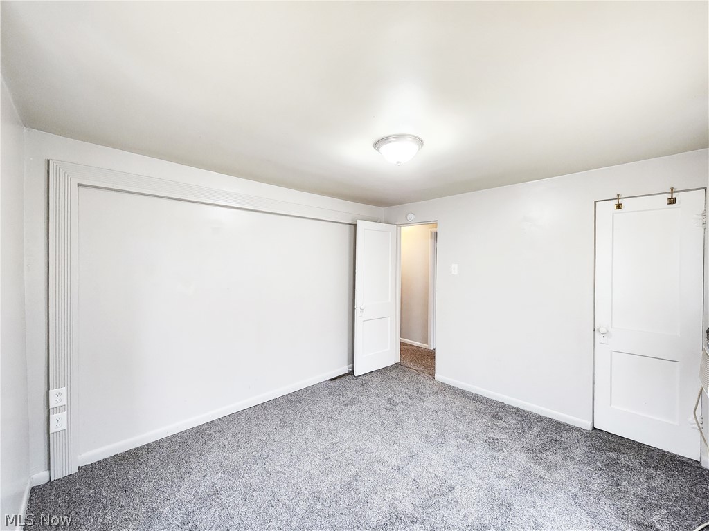 30 West Wilbeth Road, Unit A Akron, OH 44301 - Photo 9 of 16 Unfurnished bedroom featuring light carpet and a closet