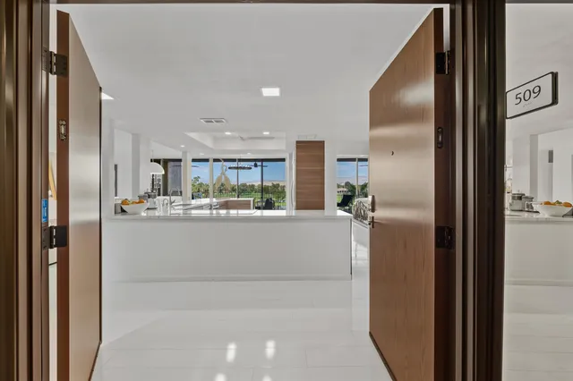 a view of kitchen with stainless steel appliances granite countertop refrigerator and sink