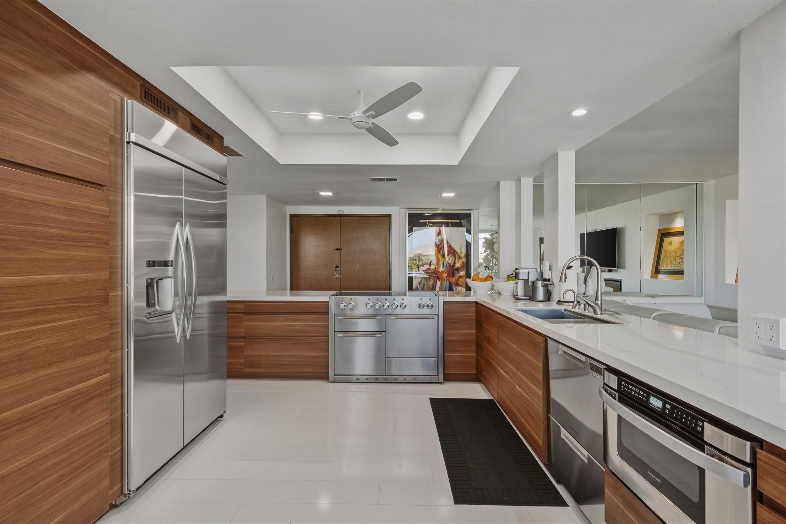 899 Island Drive, Unit 509 Rancho Mirage, CA 92270 - Photo 11 of 32 a large kitchen with stainless steel appliances a large counter top a stove and a refrigerator