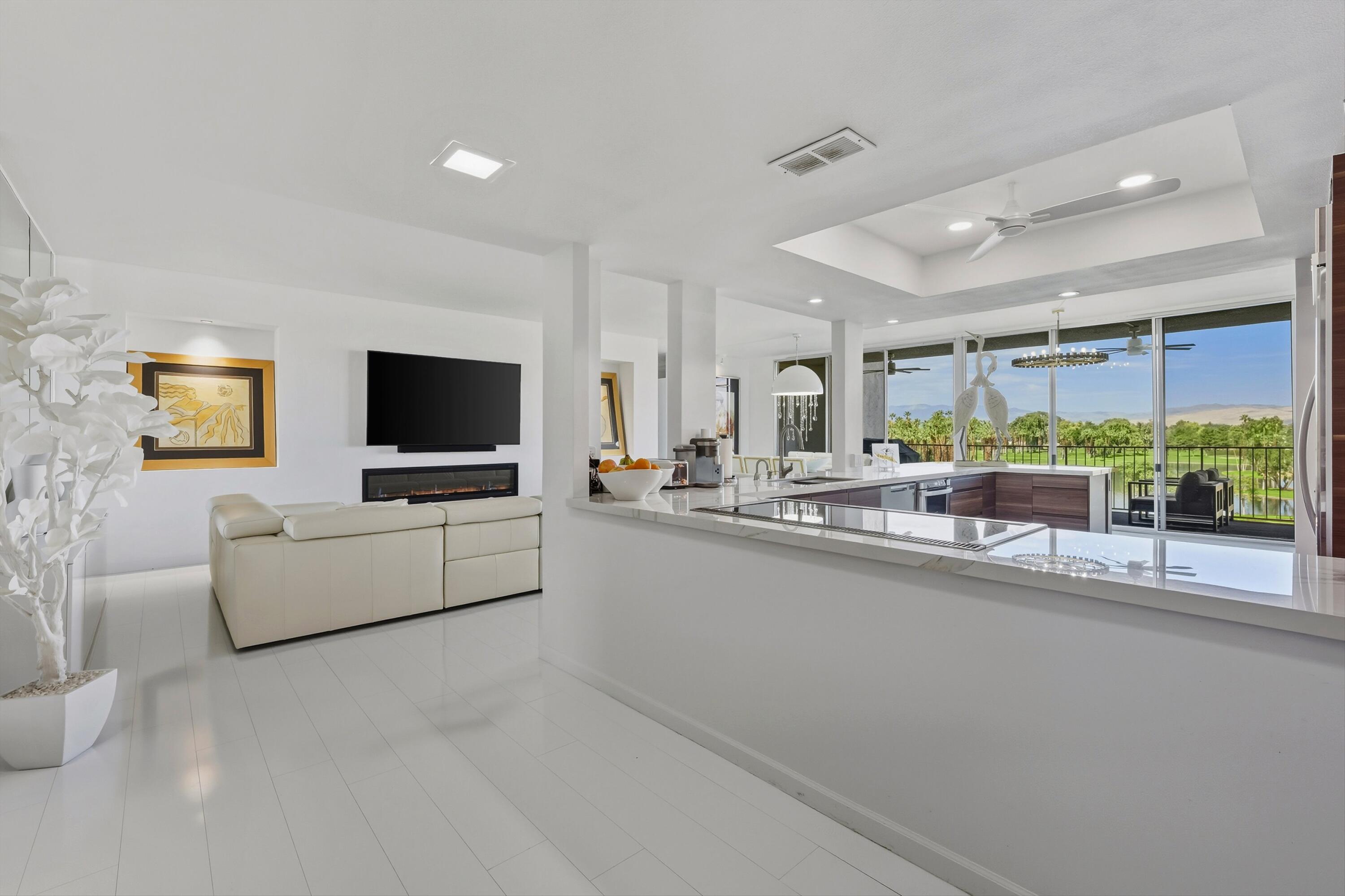 899 Island Drive, Unit 509 Rancho Mirage, CA 92270 - Photo 3 of 32 a living room with furniture and a flat screen tv
