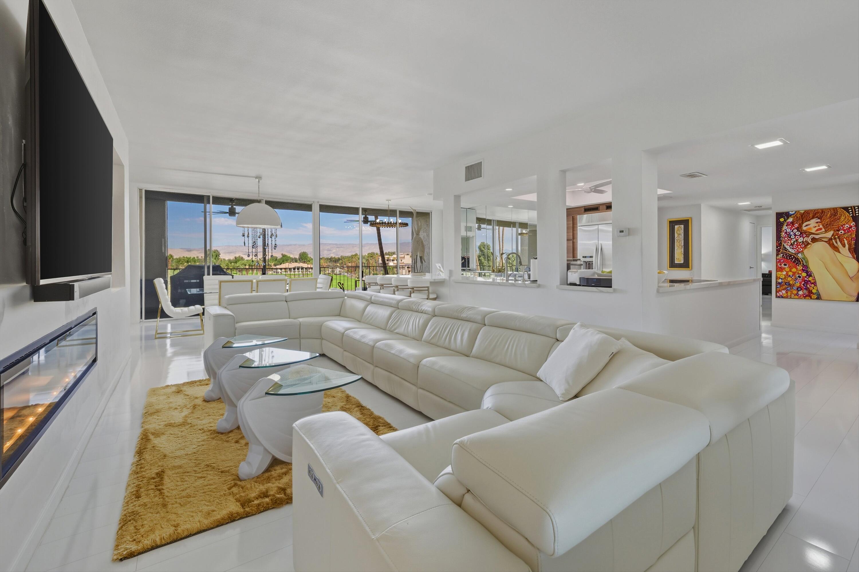 899 Island Drive, Unit 509 Rancho Mirage, CA 92270 - Photo 5 of 32 a living room with furniture and a flat screen tv