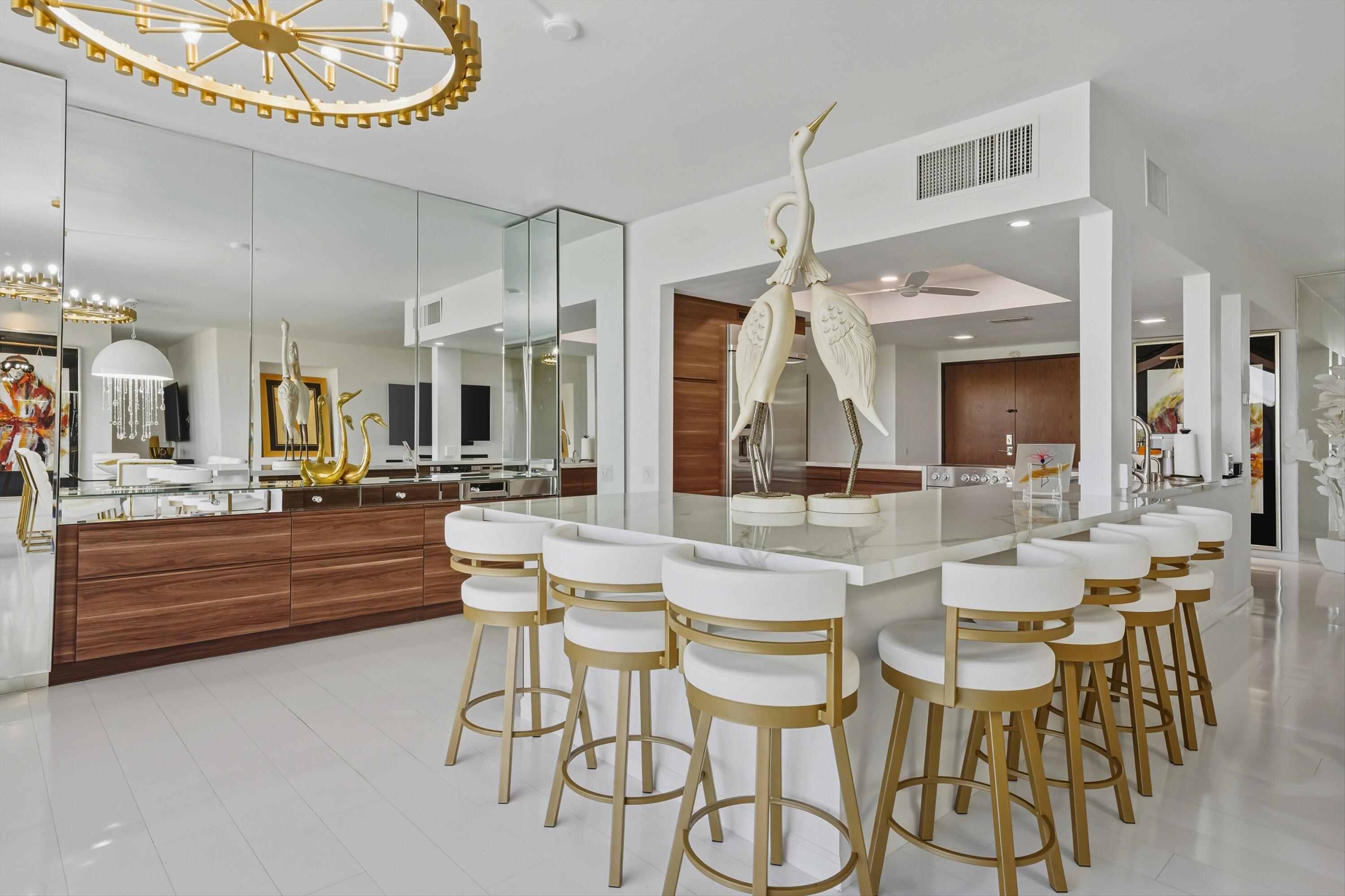 899 Island Drive, Unit 509 Rancho Mirage, CA 92270 - Photo 6 of 32 a view of a dining room with furniture and a large mirror