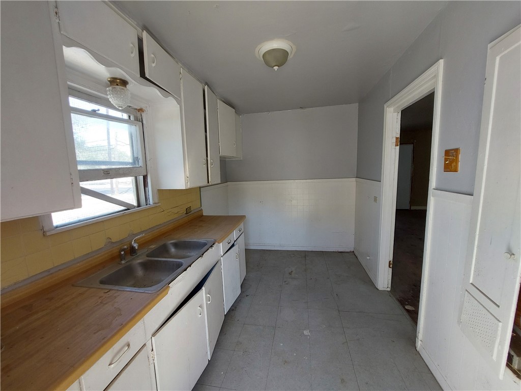 1731 15th Street Corpus Christi, TX 78404 - Photo 11 of 20 a kitchen with stainless steel appliances granite countertop a sink and a refrigerator