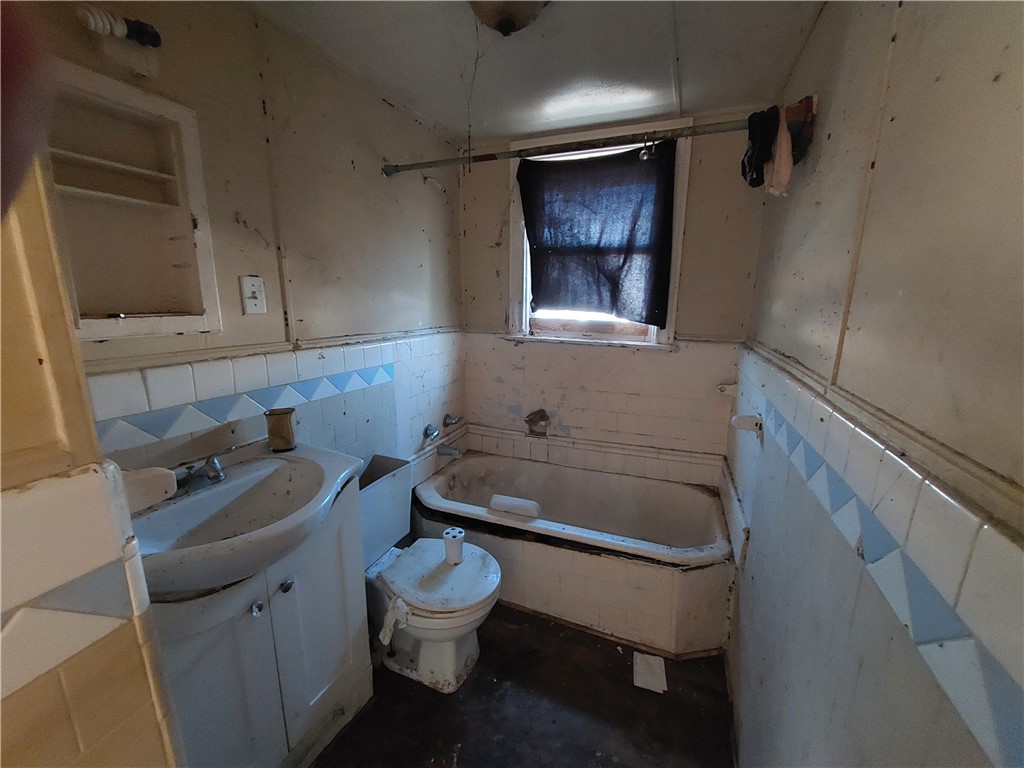 1731 15th Street Corpus Christi, TX 78404 - Photo 20 of 20 a bathroom with a toilet sink and mirror