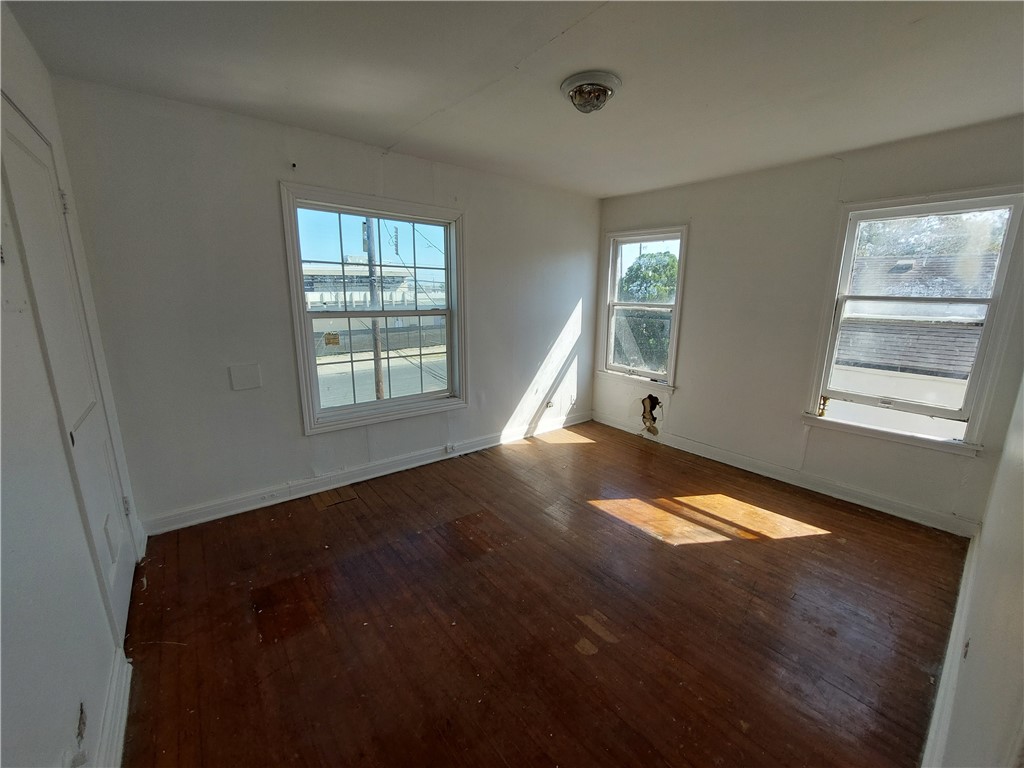 1731 15th Street Corpus Christi, TX 78404 - Photo 6 of 20 a view of an empty room with wooden floor and a window