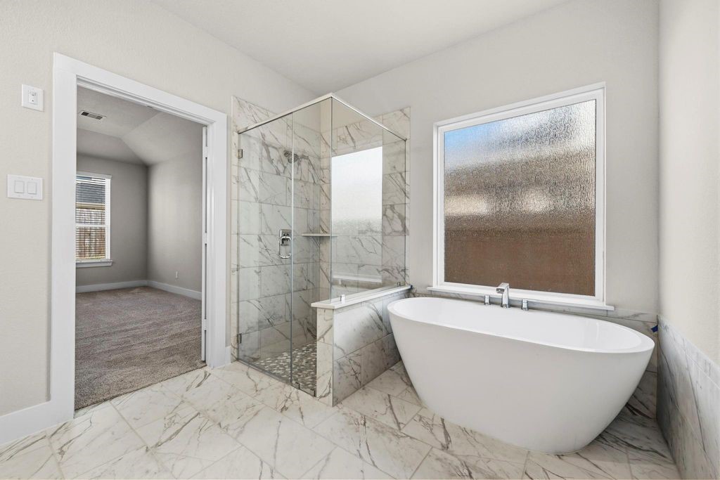 1972 Golden Spruce Lane Conroe, TX 77301 - Photo 13 of 19 a spacious bathroom with a bathtub and shower