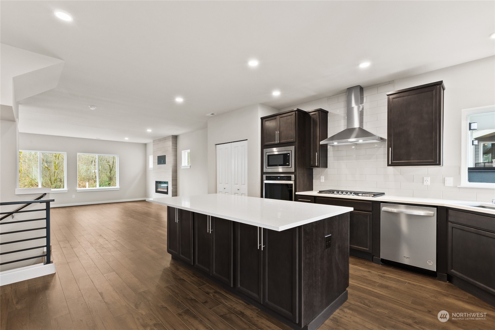 413 207th Street Southeast Bothell, WA 98012 - Photo 13 of 32 a kitchen with stainless steel appliances granite countertop a sink a stove a refrigerator and island with wooden floor