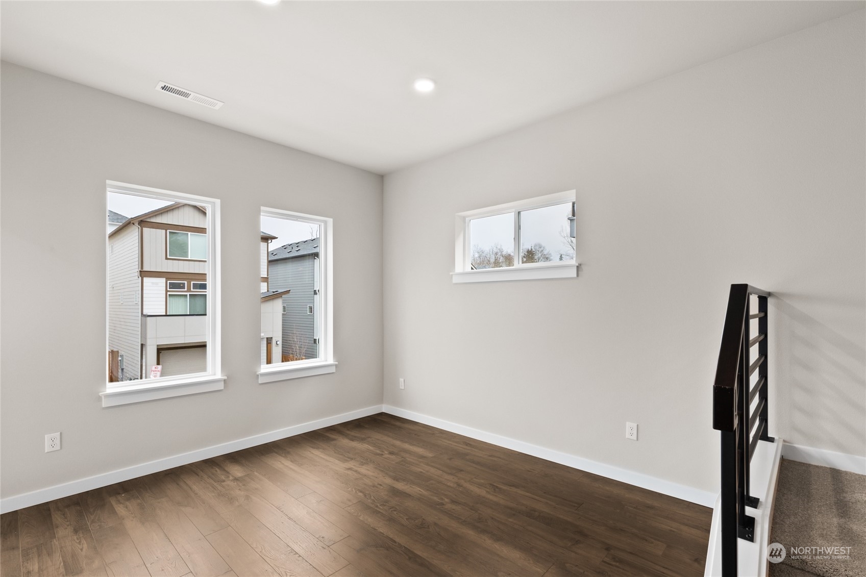 413 207th Street Southeast Bothell, WA 98012 - Photo 14 of 32 a view of an empty room with wooden floor and a window