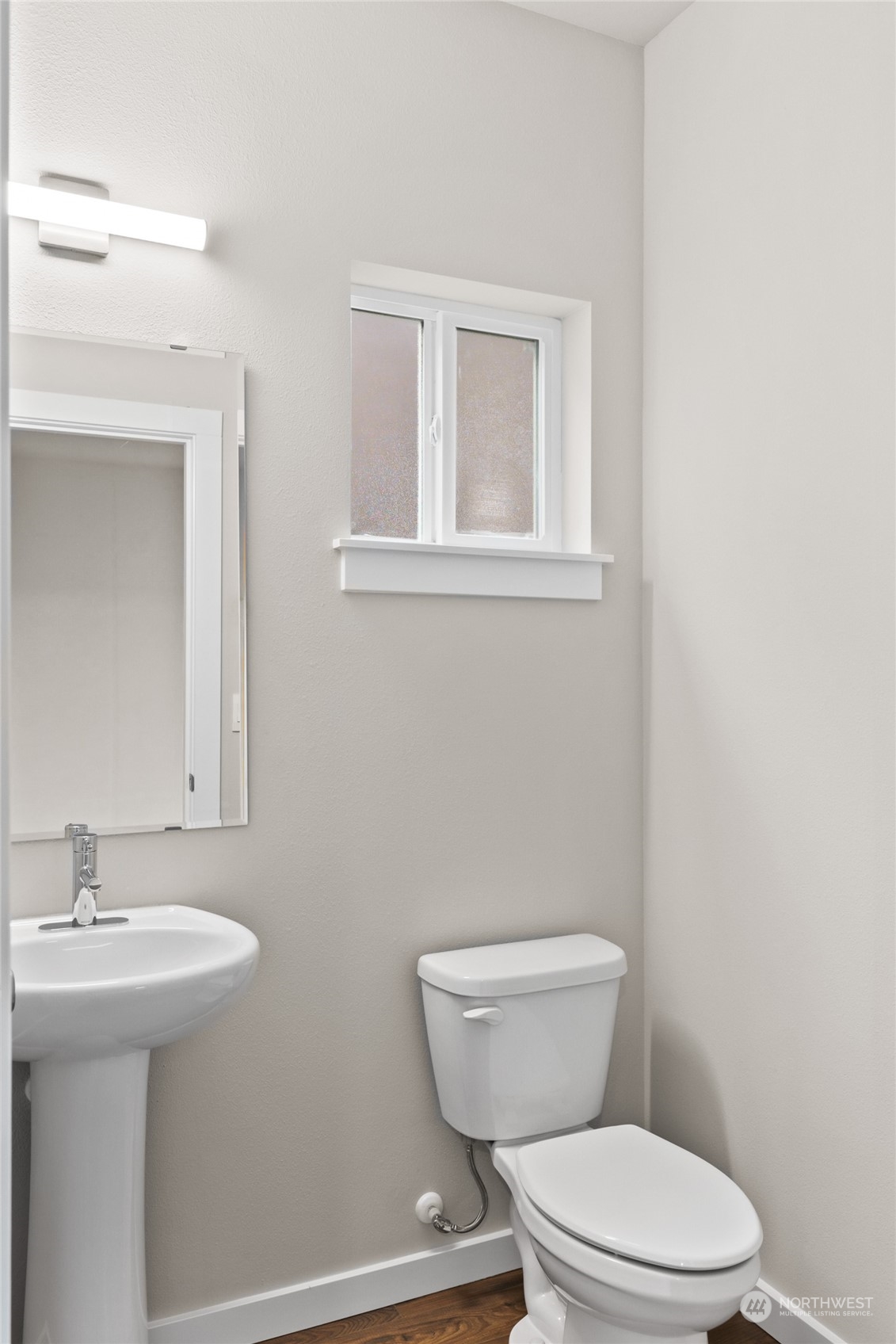 413 207th Street Southeast Bothell, WA 98012 - Photo 16 of 32 a bathroom with a toilet a sink a mirror and vanity