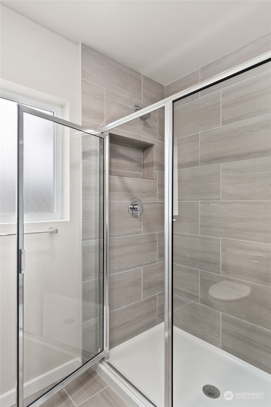 413 207th Street Southeast Bothell, WA 98012 - Photo 19 of 32 a bathroom with a glass shower door