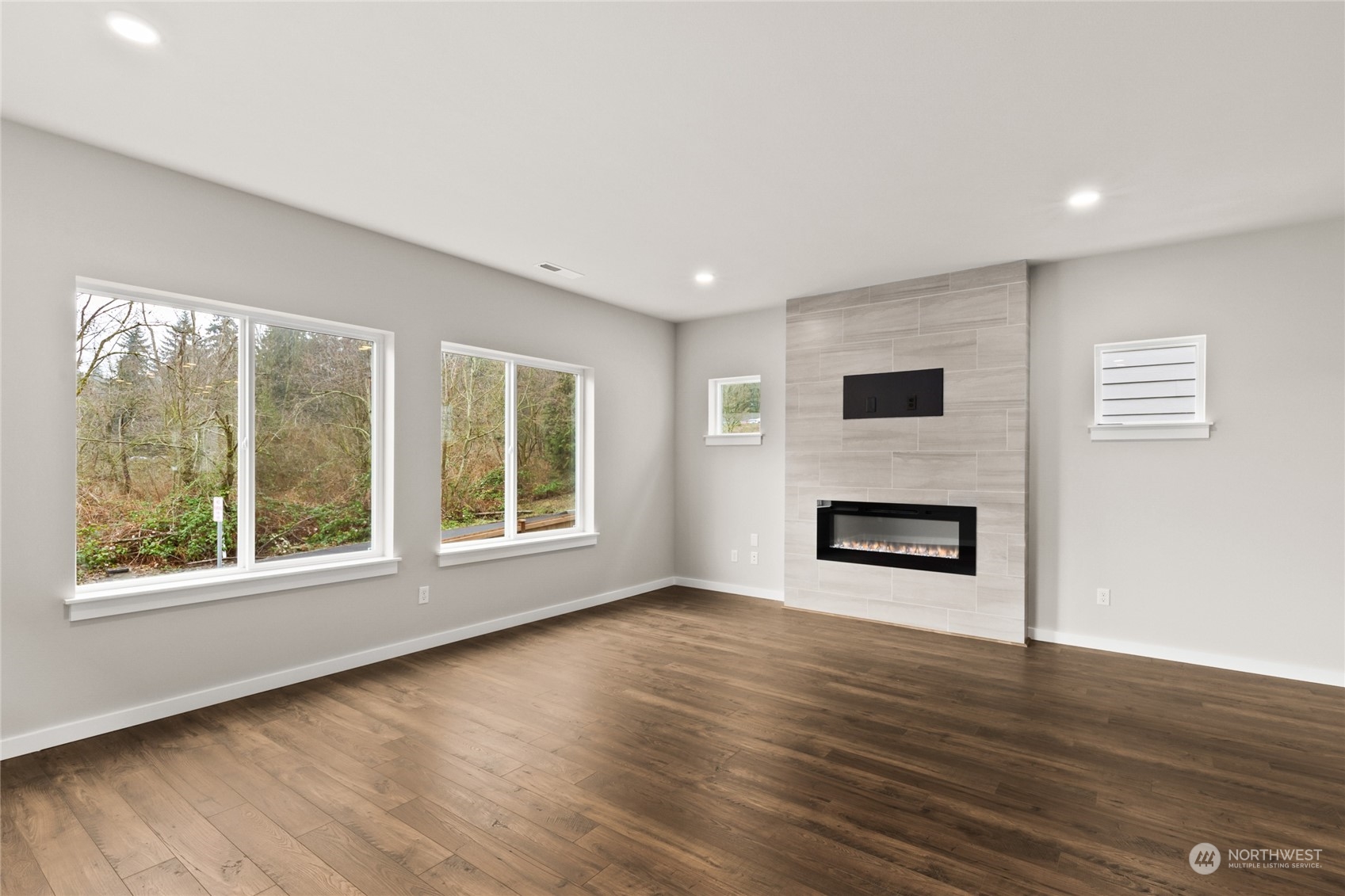 413 207th Street Southeast Bothell, WA 98012 - Photo 6 of 32 a view of a livingroom with wooden floor and a fireplace