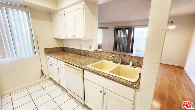 a bathroom with a granite countertop sink and a vanity