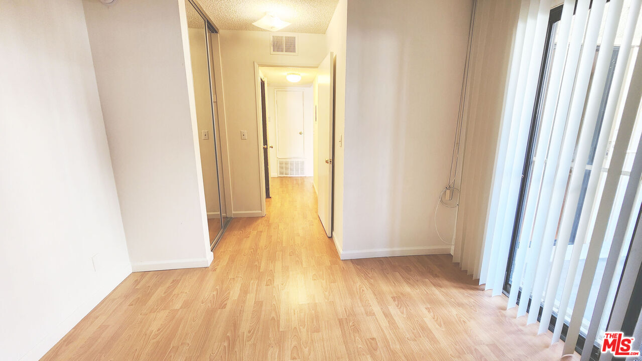 1425 West 12th Street, Unit 161 Los Angeles, CA 90015 - Photo 4 of 19 a view of a hallway with wooden floor