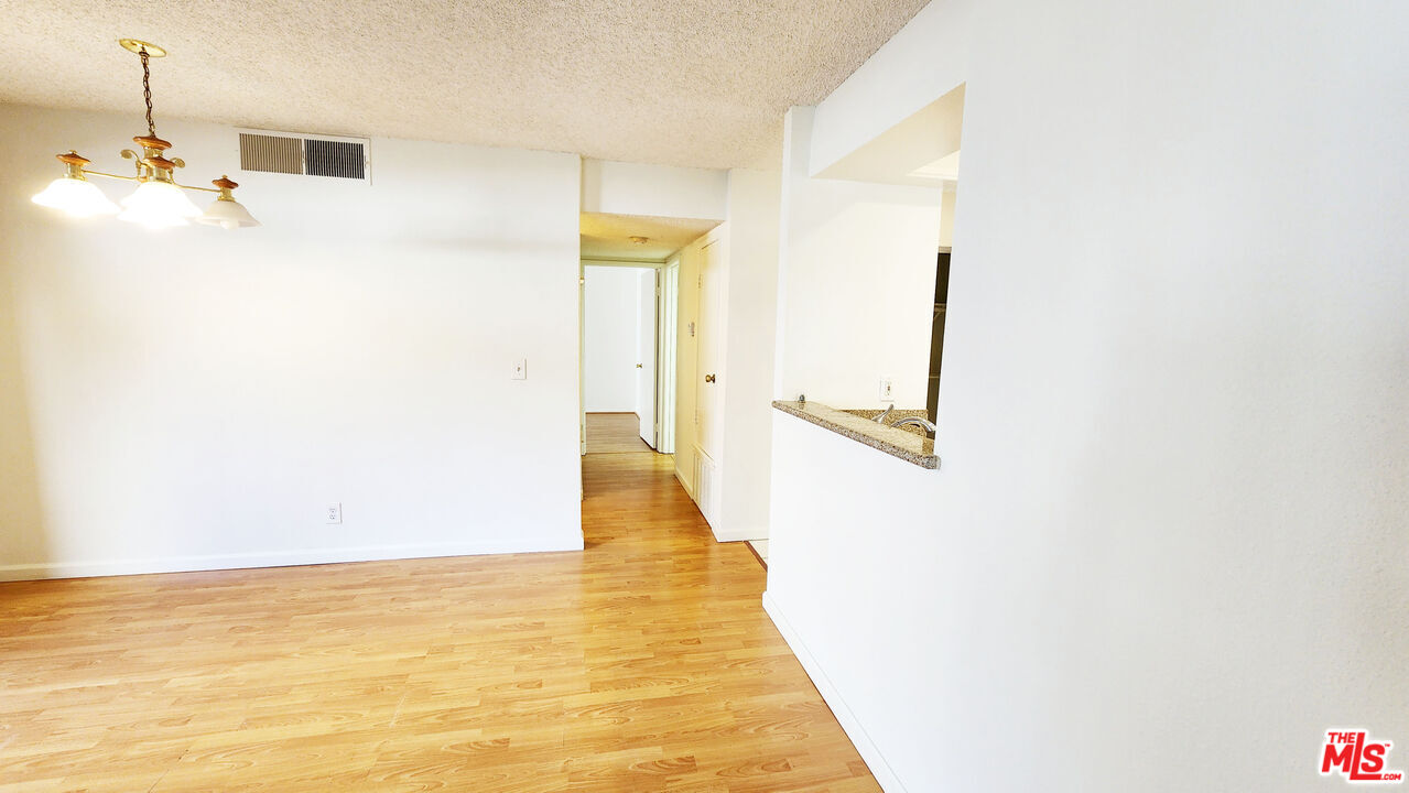 1425 West 12th Street, Unit 161 Los Angeles, CA 90015 - Photo 5 of 19 a view of a hallway with wooden floor