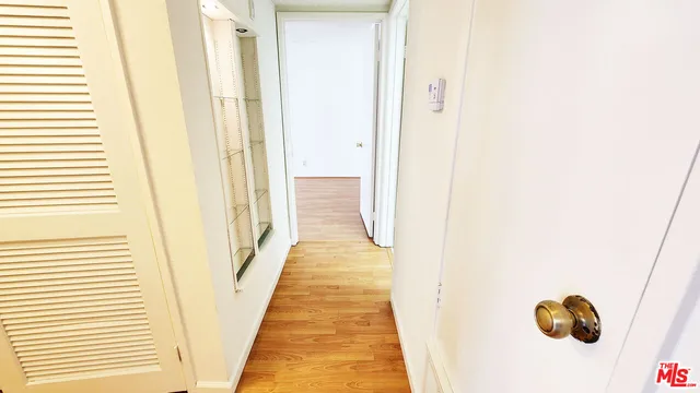 a view of a hallway with wooden floor