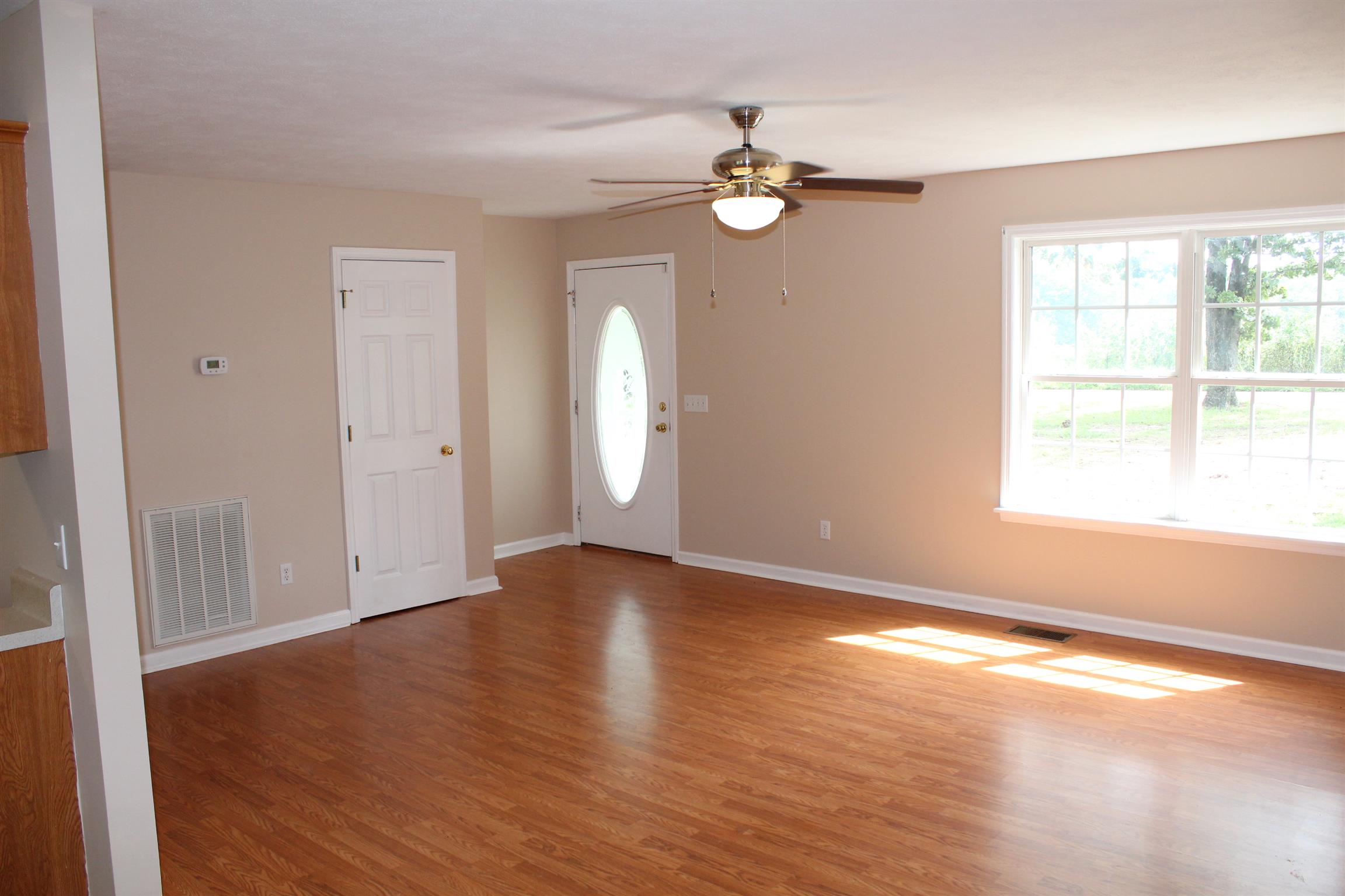 278 Baker Road Dickson, TN 37055 - Photo 5 of 26 an empty room with wooden floor and windows