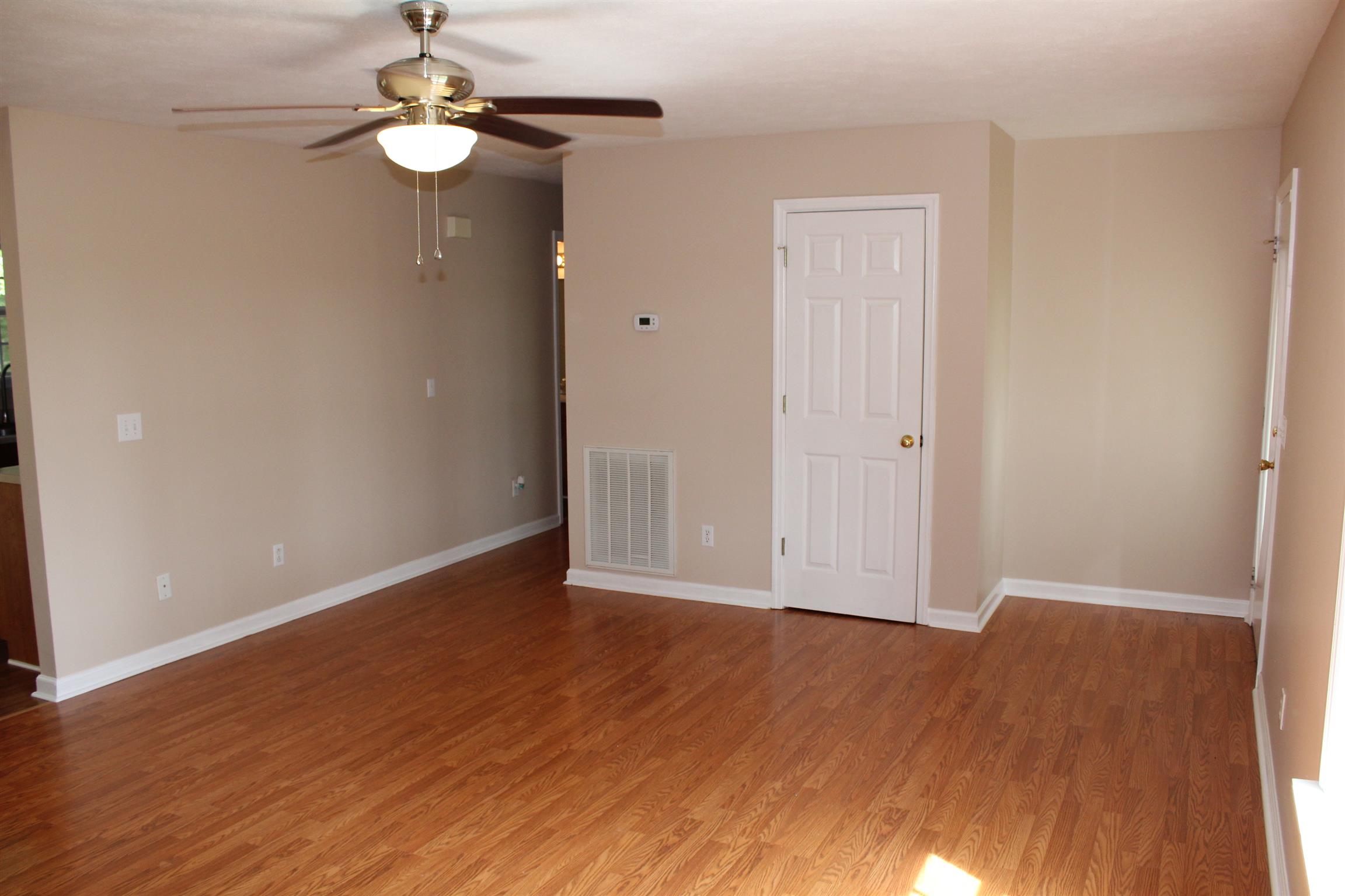 278 Baker Road Dickson, TN 37055 - Photo 7 of 26 an empty room with wooden floor and chandelier