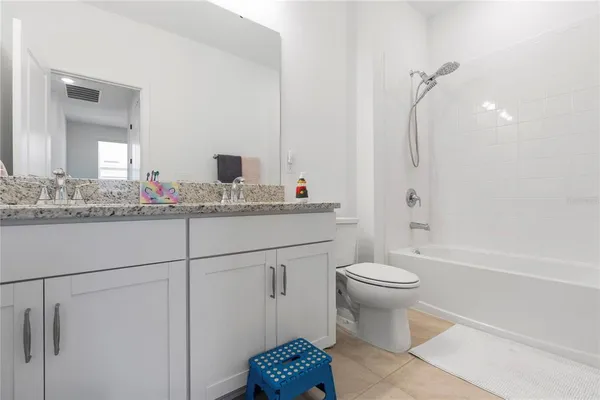 a bathroom with a sink toilet vanity and tub
