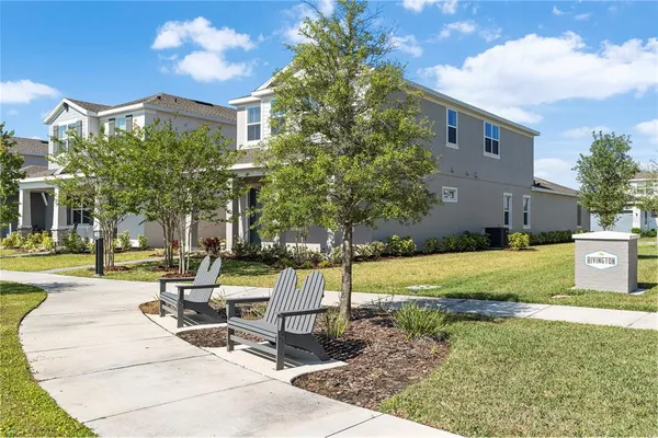 a view of a house with backyard porch and sitting area
